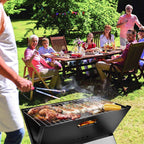 Portable charcoal barbecue grill used for outdoor family gathering and backyard picnic cooking